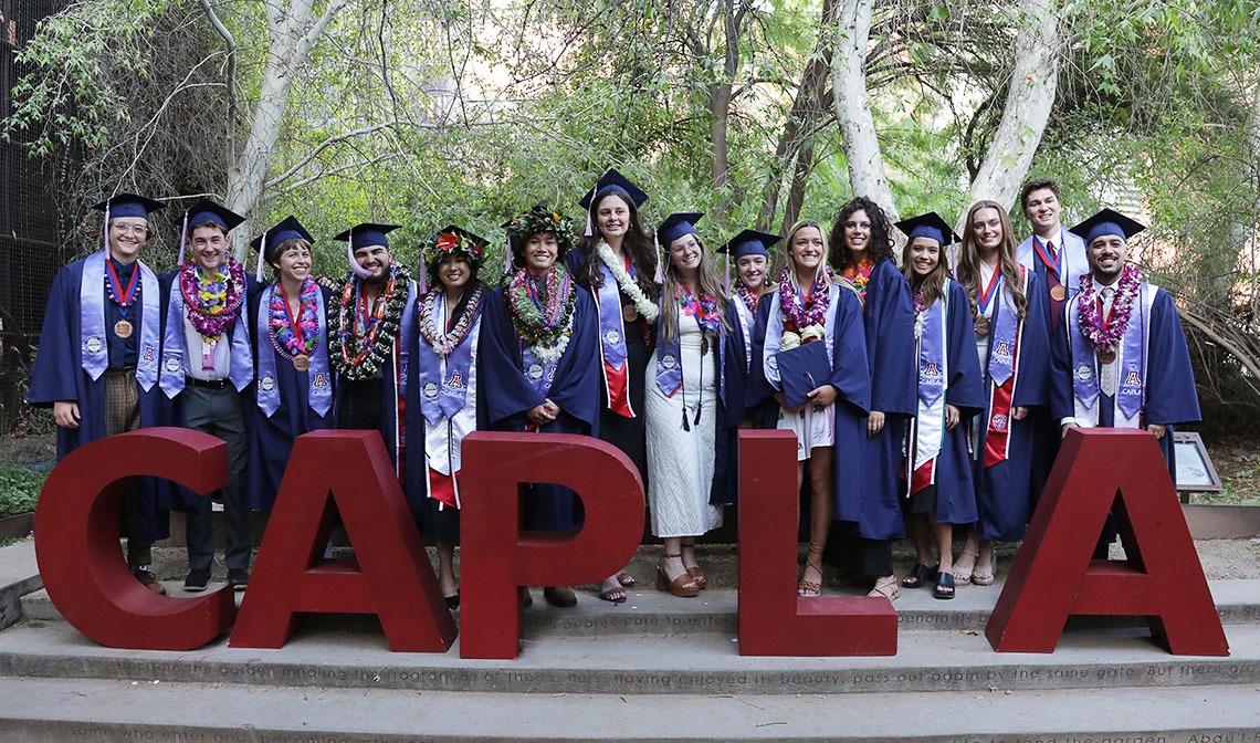 CAPLA Class of 2023 graduates with CAPLA red foam letters