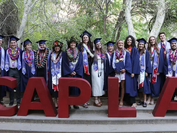 CAPLA Class of 2023 graduates with CAPLA red foam letters