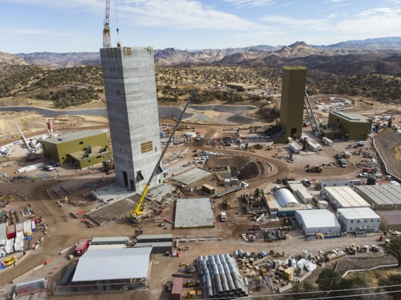 Construction equipment and vehicles surround a mining facility. 