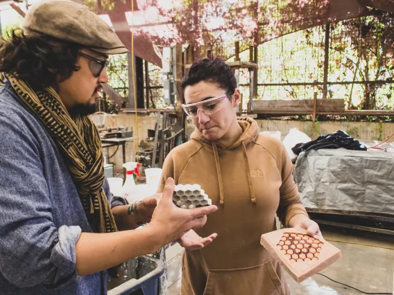 A student with a faculty member assessing a 3D mold for material fabrication