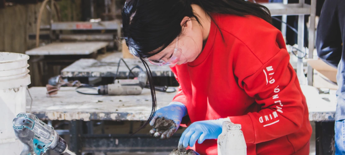 A student using concrete in the concrete lab at the college of architecture, planning and landscape architecture