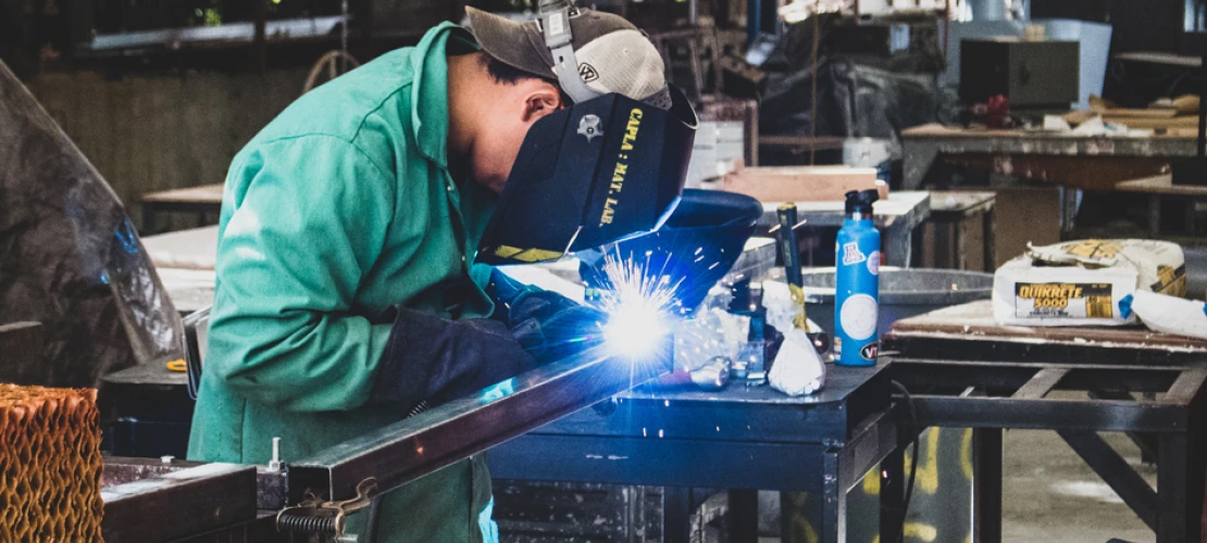 A CAPLA student welding a piece of metal on to an architecture structure