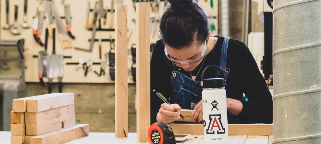 A photo of a student in the wood lab at the college of architecture, planning and landscape architecture