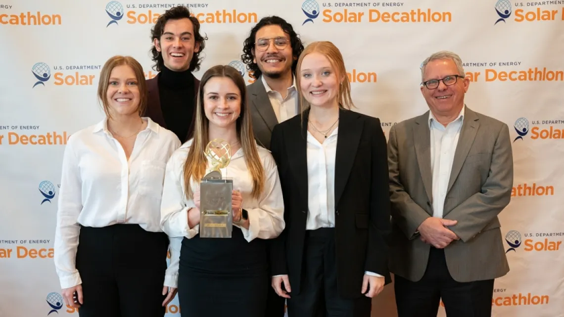 Group of CAPLA students and David Brubaker posing with their Solar Decathlon Design Award. 