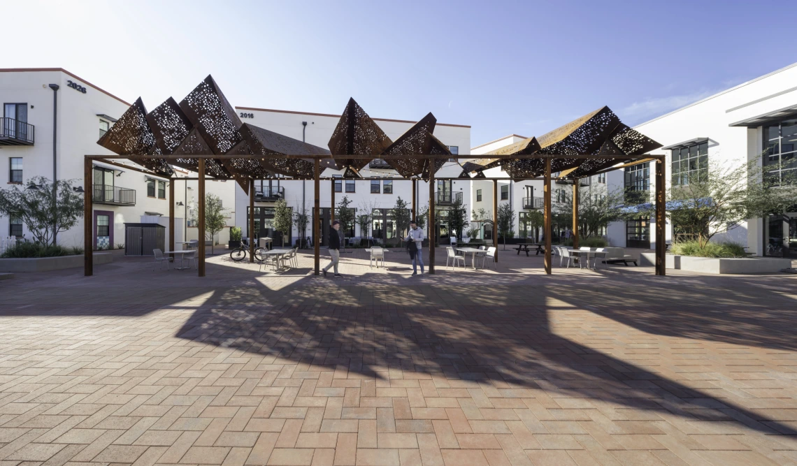 CoLab photo of an exterior building with extruding shadows from an intricate overhead structure
