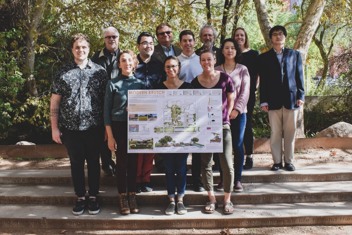 Students and jury members stand in the Underwood garden with project poster.