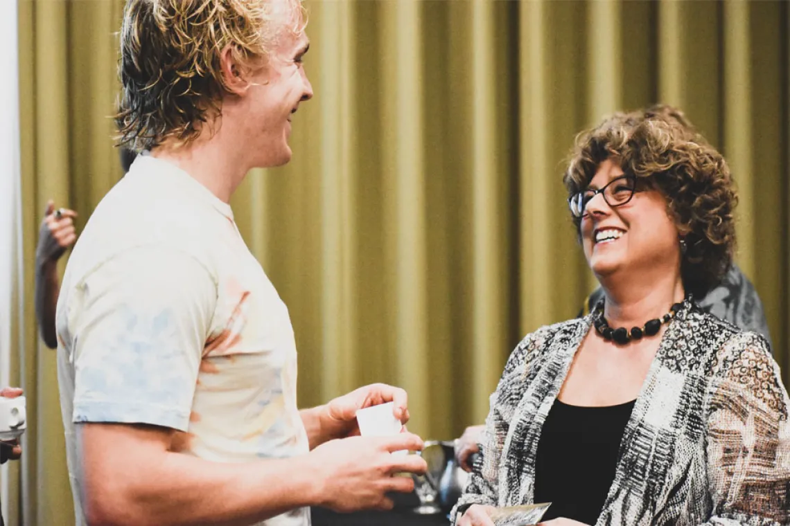 Esther Sternberg speaks with a conference attendant after her lecture, Creating Spaces for Healthy Aging