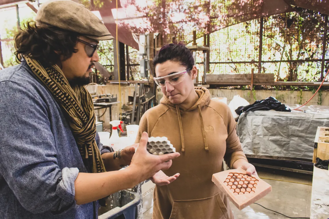 A student with a faculty member assessing a 3D mold for material fabrication