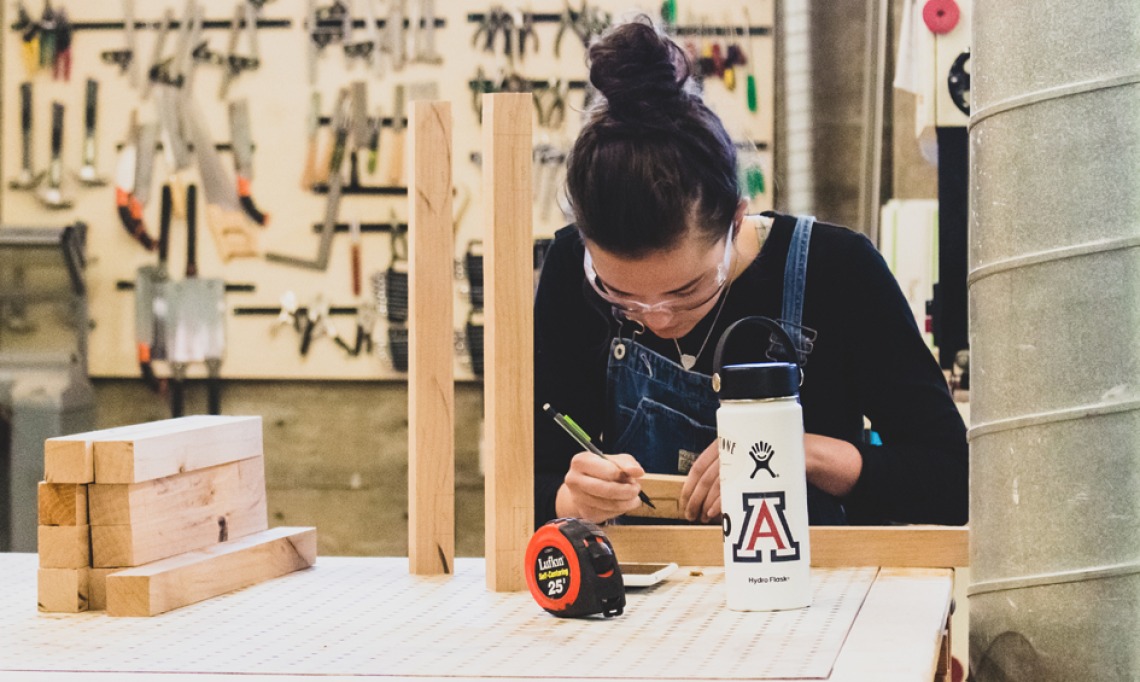 A photo of a student in the wood lab at the college of architecture, planning and landscape architecture