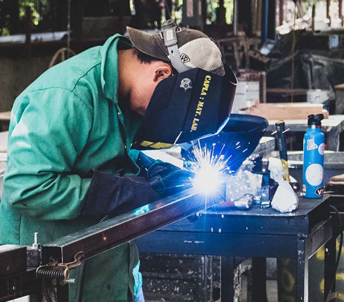 Architecture student welding in Materials Lab.