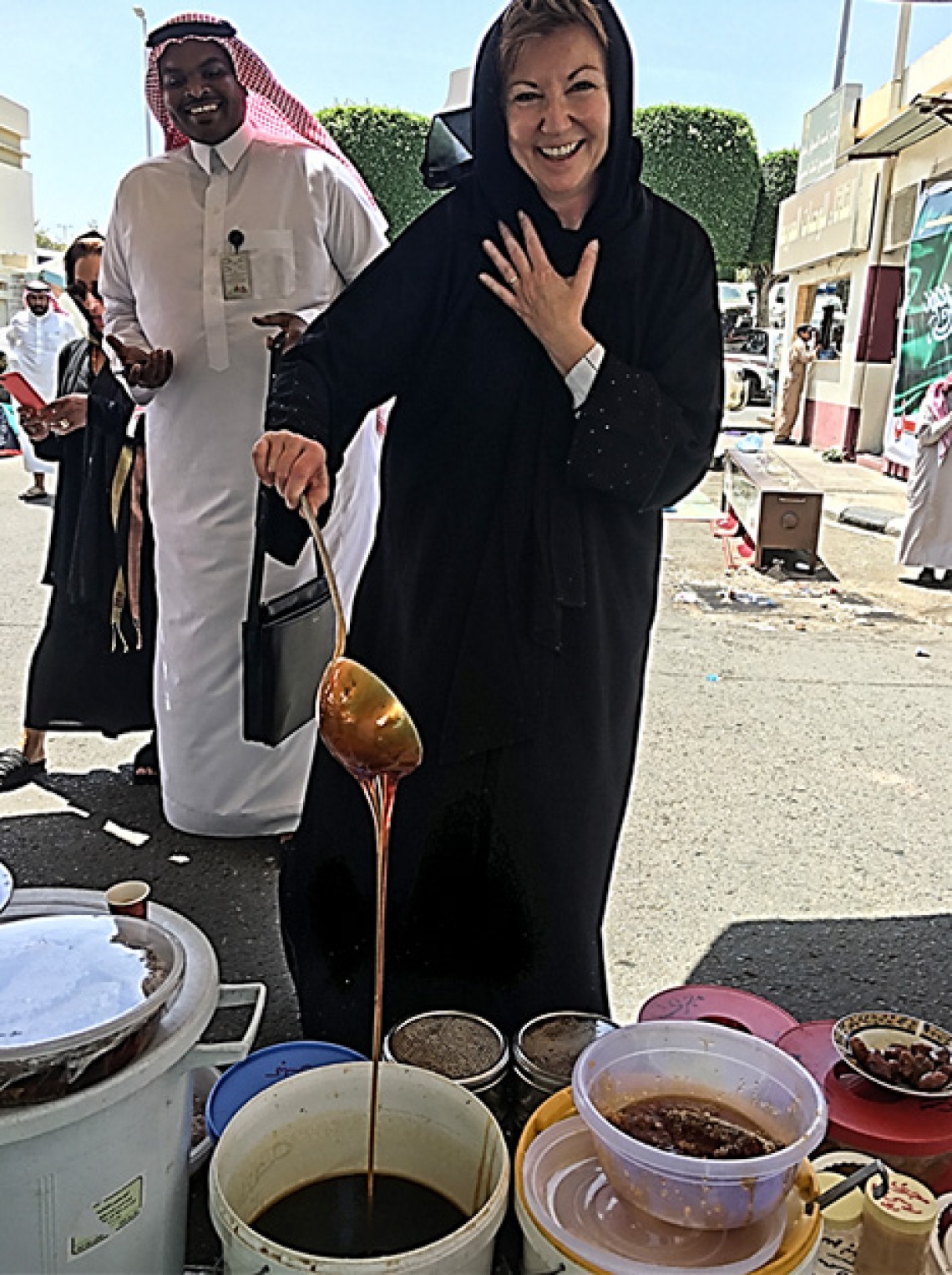 Nancy Pollock-Ellwant checking honey in Saudi Arabia