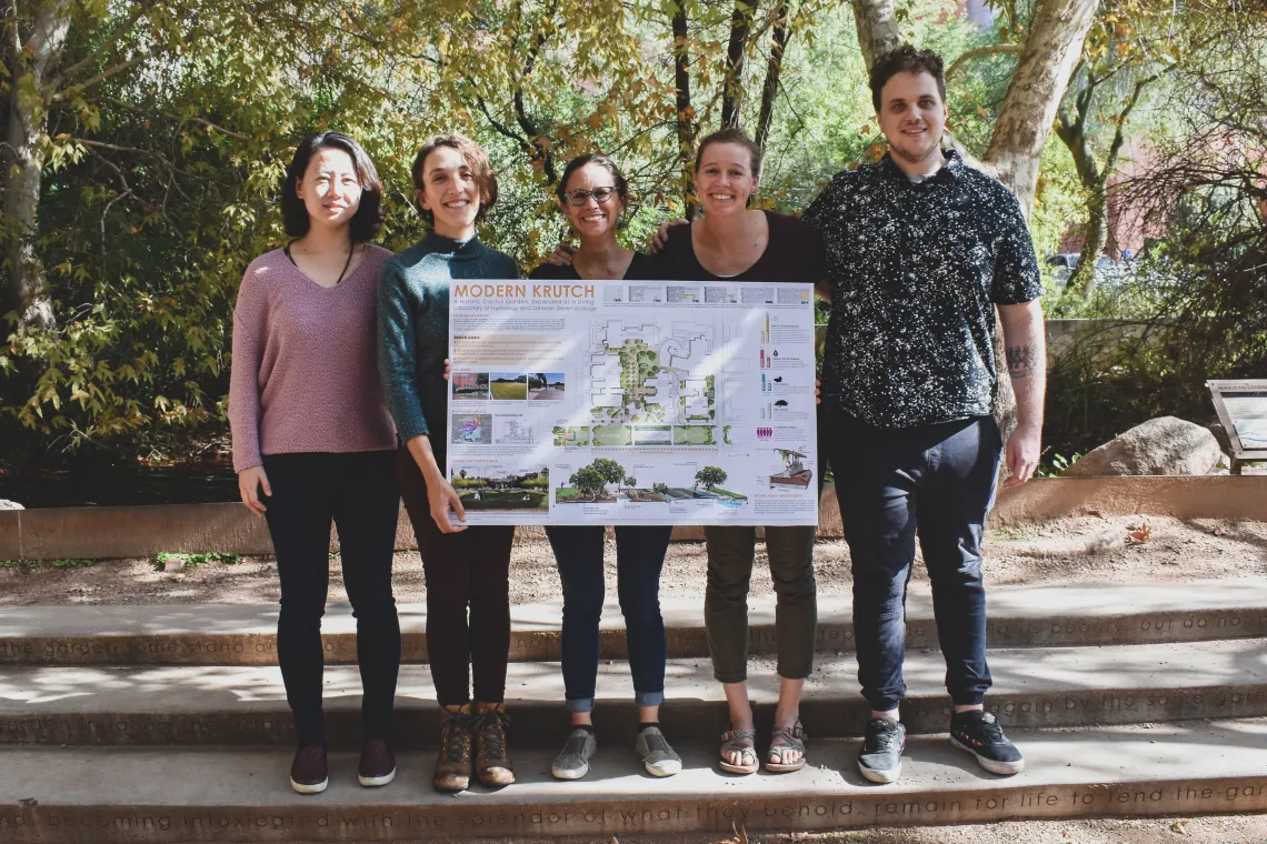 Students stand in the Underwood garden with project poster.