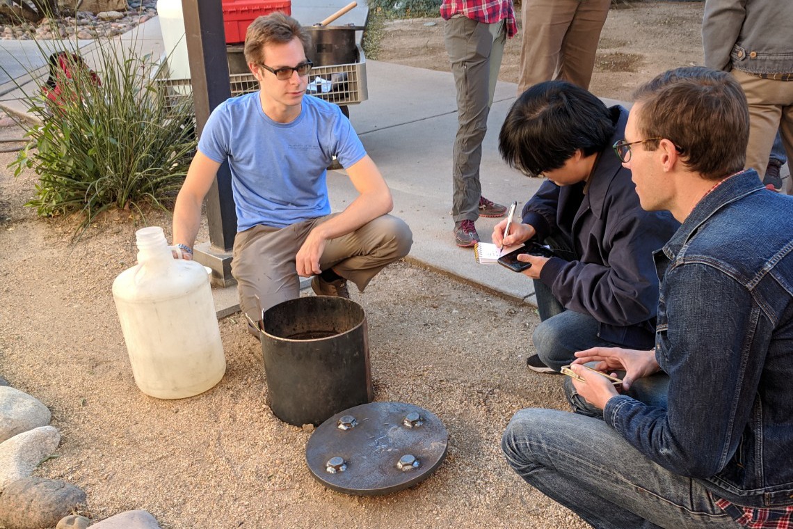 Students conduct a soil percolation test