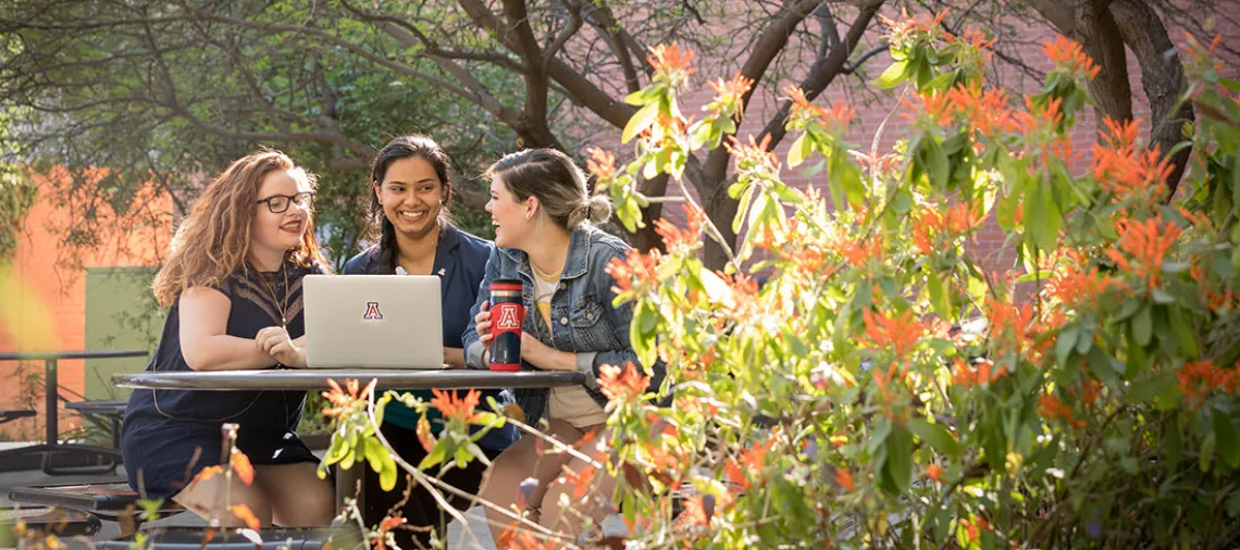 CAPLA students with laptop in Underwood Garden