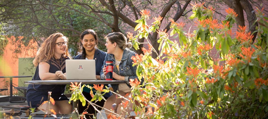 CAPLA students with laptop in Underwood Garden
