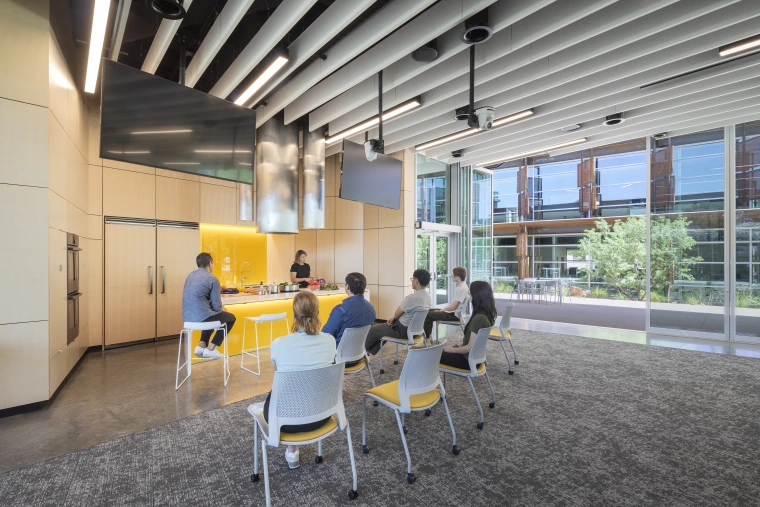 Photo of a group of people watching a cooking demonstration in the Weil Center Body Building