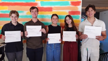 Students posing with their certificates. 