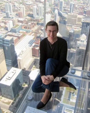 Lisa Schrenk in observation deck with glass floor over Chicago